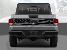 Load image into Gallery viewer, Rear view of a silver 2020+ Jeep Gladiator pickup truck with a black tailgate decal featuring an American flag design, Jeep logo, and Gladiator emblem, showcasing the custom vinyl accessory for the vehicle&#39;s tailgate.