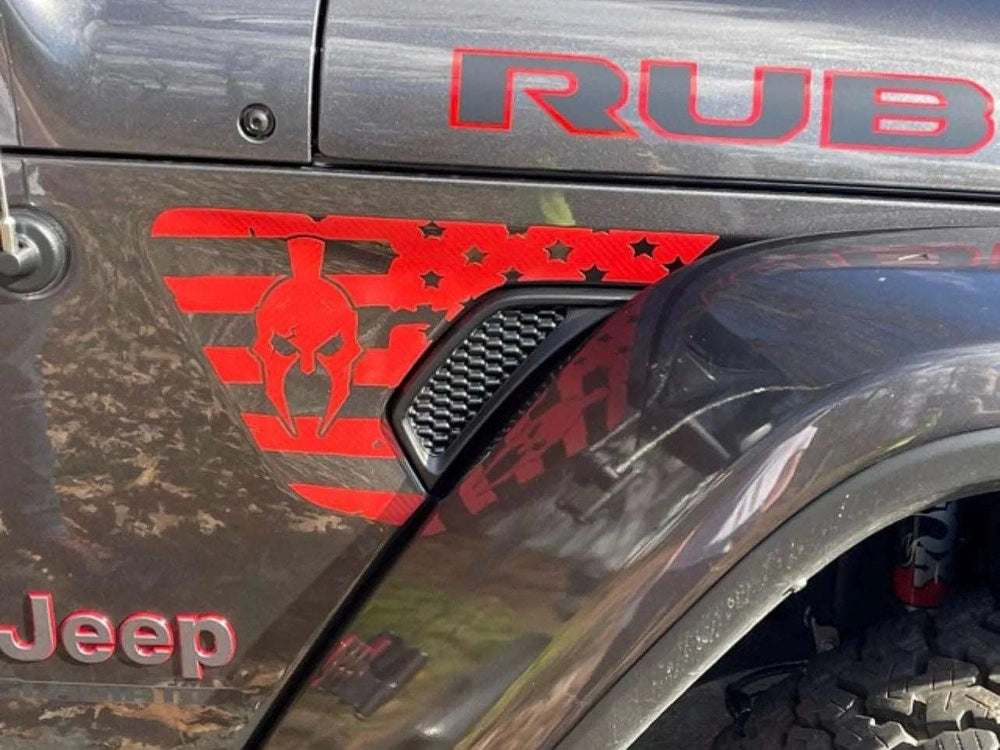 Red Wrangler Gladiator fender vent decal featuring American flag design with skull overlay on gray Jeep body, showcasing custom styling and patriotic theme for off-road enthusiasts