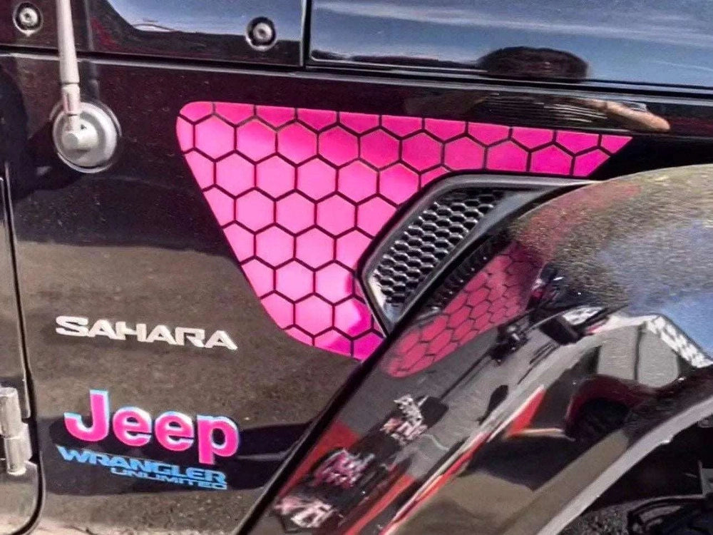 Bright pink honeycomb pattern decal applied to black Jeep Wrangler Sahara fender vent, showcasing custom design and precise fitment for vehicle modification
