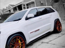 Load image into Gallery viewer, White Jeep Grand Cherokee with custom orange wheels parked on a residential street, showcasing sleek profile and performance upgrades