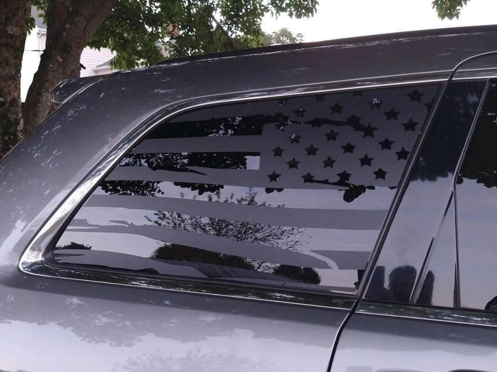 Jeep Grand Cherokee with American flag decal applied to rear quarter window, showcasing patriotic design and custom appearance for 2011-2021 models