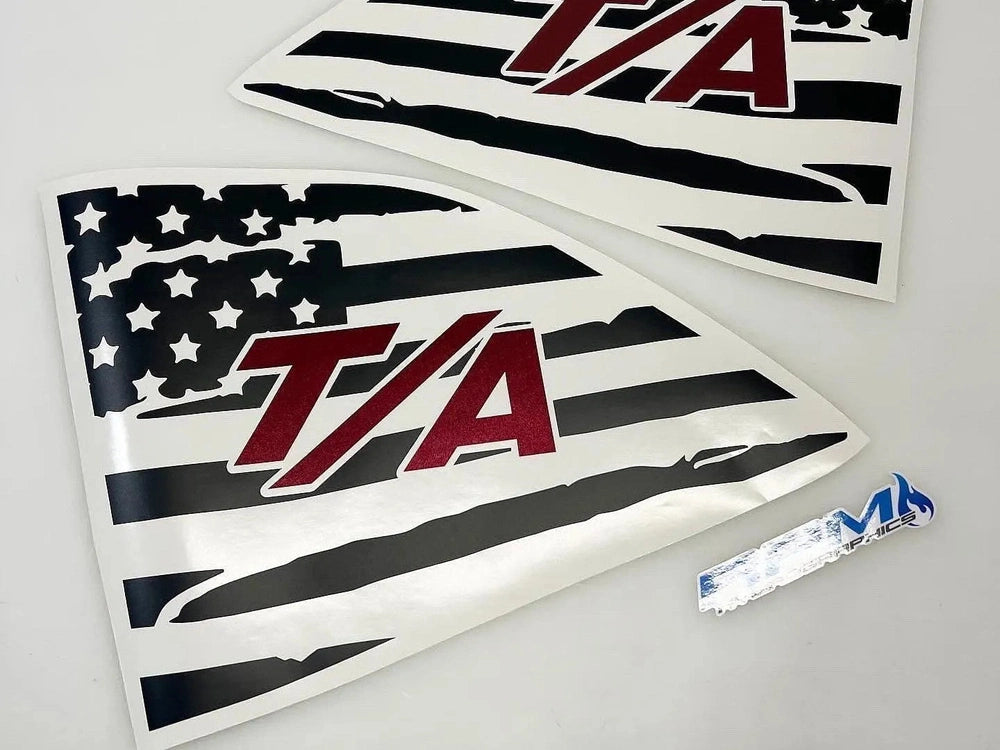 Challenger quarter window decals featuring American flag design with T/A logo in red, black, and white. Two triangular decals shown with installation tool.