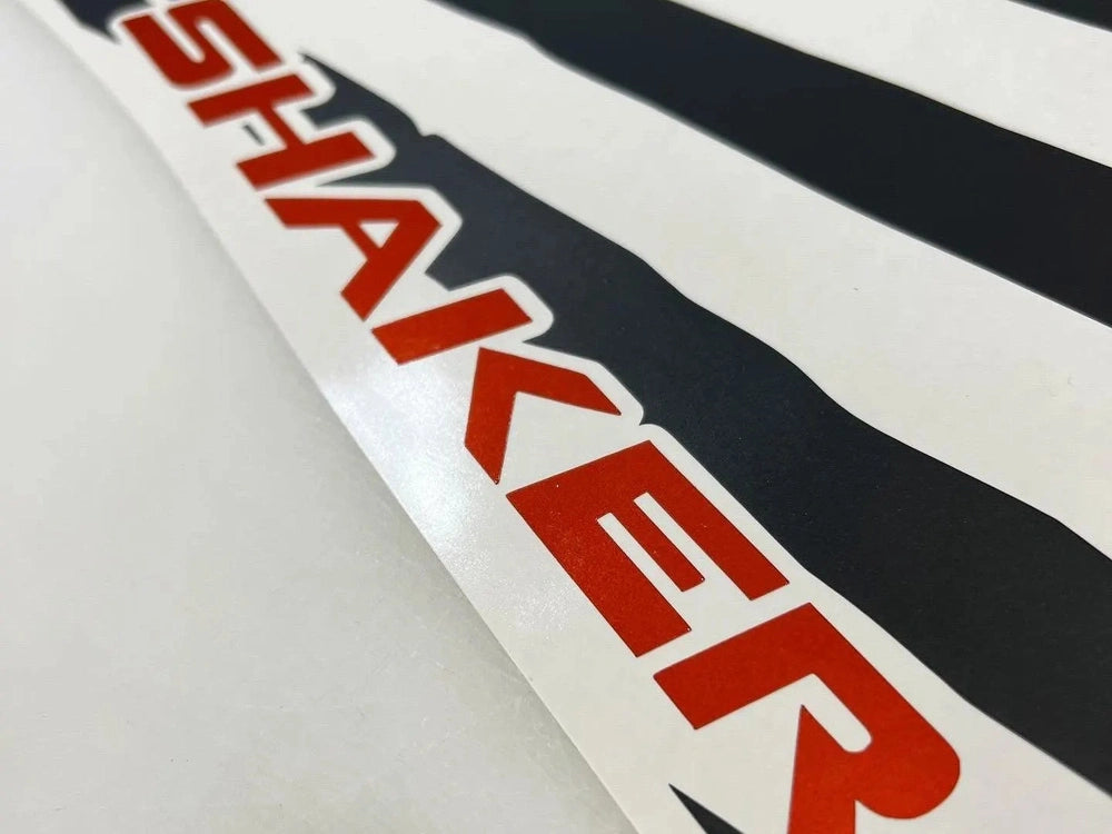 Close-up of red "SHAKER" decal on white background with black stripes, showcasing Challenger quarter window decal design for customization
