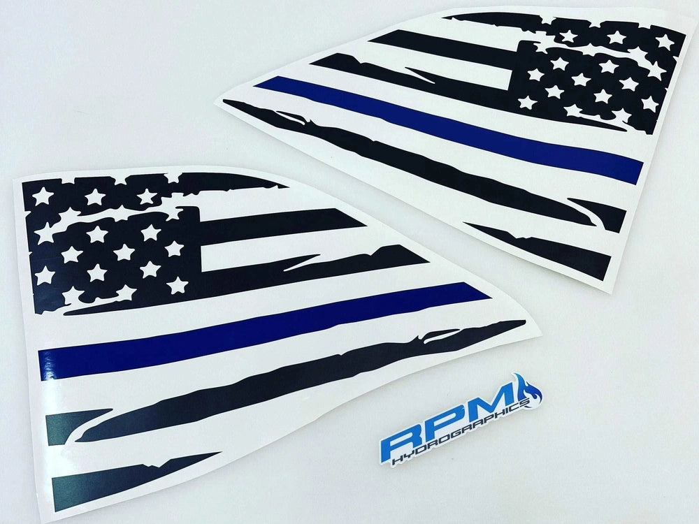 Thin blue line American flag quarter window decals for Dodge Challenger, showing distressed design with black and white stripes and blue line. Two identical triangular stickers displayed side by side on white background with RPM logo.