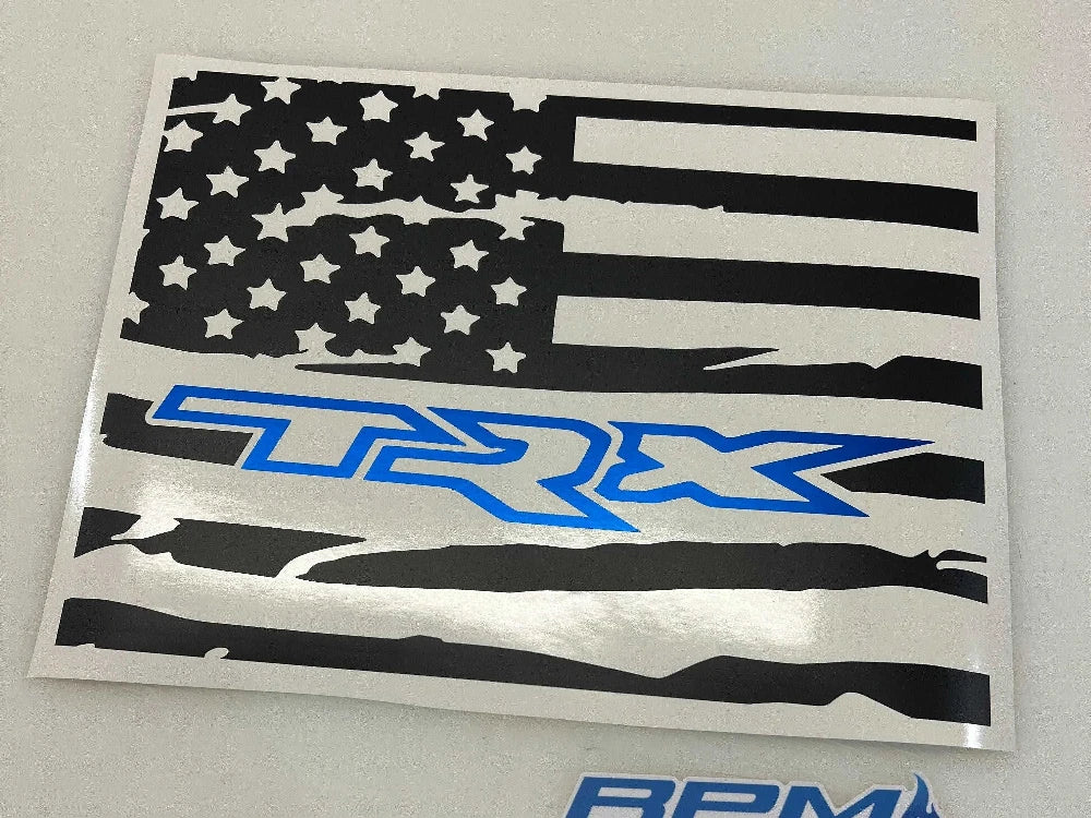 Custom RAM truck rear window decal featuring distressed American flag design with TRX logo in blue, showcasing patriotic style for 2009+ RAM pickups