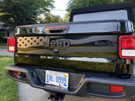 Black Jeep Gladiator tailgate with American flag-inspired decal featuring stars and stripes design, showcasing patriotic customization for 2020+ models