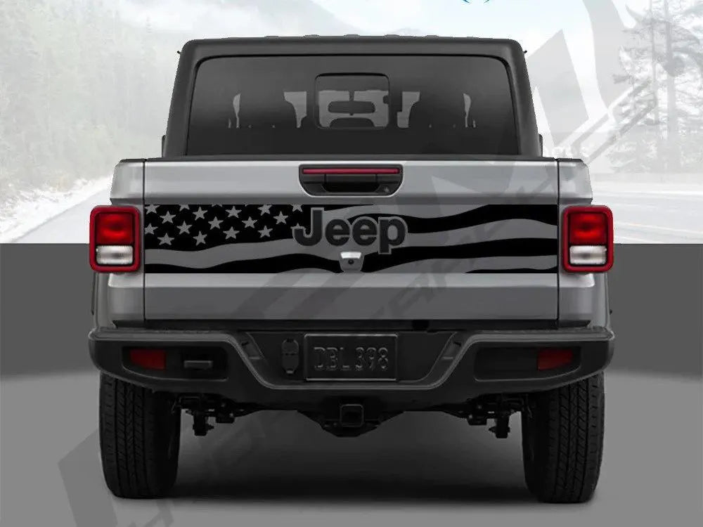 Rear view of a silver 2020+ Jeep Gladiator with a black American flag decal spanning the tailgate, showcasing patriotic customization for the vehicle's exterior design
