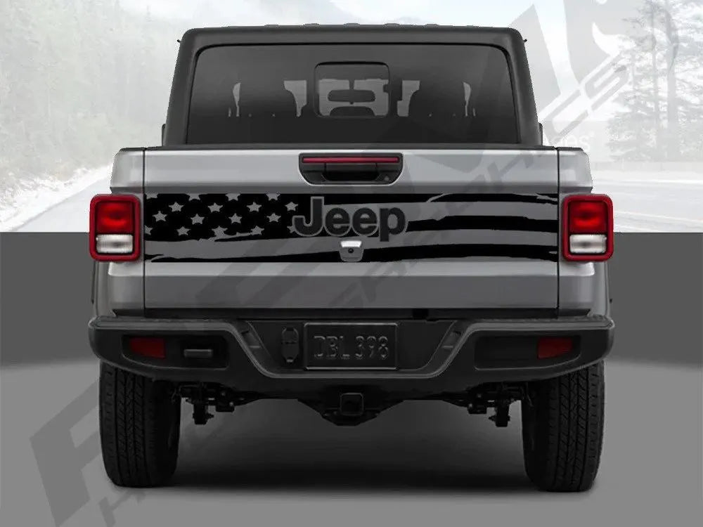 Rear view of a 2020+ Jeep Gladiator with an American flag tailgate decal, showcasing the patriotic design and custom look on the silver-gray truck body, emphasizing the unique vinyl application for Jeep enthusiasts.