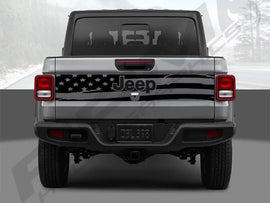 Rear view of a 2020+ Jeep Gladiator with an American flag tailgate decal, showcasing the patriotic design and custom look on the silver-gray truck body, emphasizing the unique vinyl application for Jeep enthusiasts.