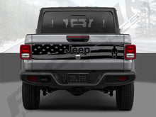 Load image into Gallery viewer, Rear view of a silver Jeep Gladiator truck with a tailgate decal featuring a black and white American flag design and Jeep logo, showcasing the custom vinyl decal product for 2020+ models.