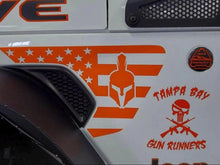 Load image into Gallery viewer, Orange American flag decal with Spartan helmet on white Jeep fender vent, alongside Tampa Bay Gun Runners logo, showcasing custom Wrangler or Gladiator fender vent decals for patriotic and personalized vehicle styling