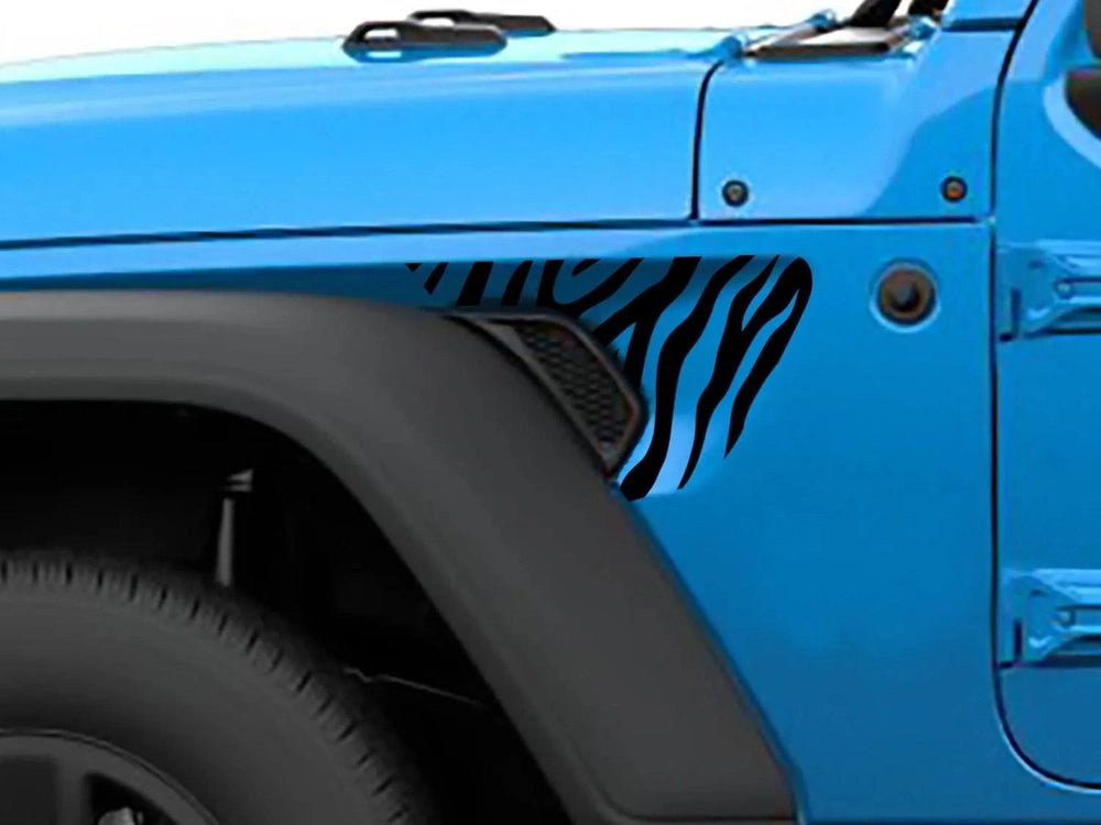 Blue Jeep Wrangler fender with black zebra stripe decal, showcasing custom fender vent decoration for Wrangler and Gladiator models, highlighting the unique and stylish appearance of the vehicle modification