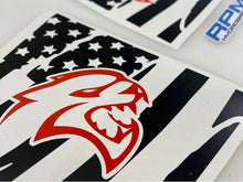 Load image into Gallery viewer, Close-up of Charger Hellcat logo decal with American flag pattern, showcasing red and black designs on white background for custom Dodge Charger quarter window application