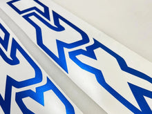Load image into Gallery viewer, TRX logo windshield banner decal in blue and white, showcasing sleek design and precision cut for custom truck appearance. Close-up view highlights premium vinyl quality and professional finish.